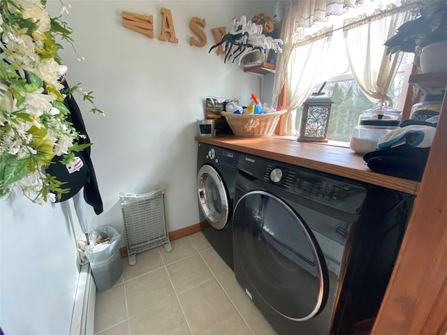laundry area with laundry area, baseboards, light tile patterned floors, and washing machine and clothes dryer