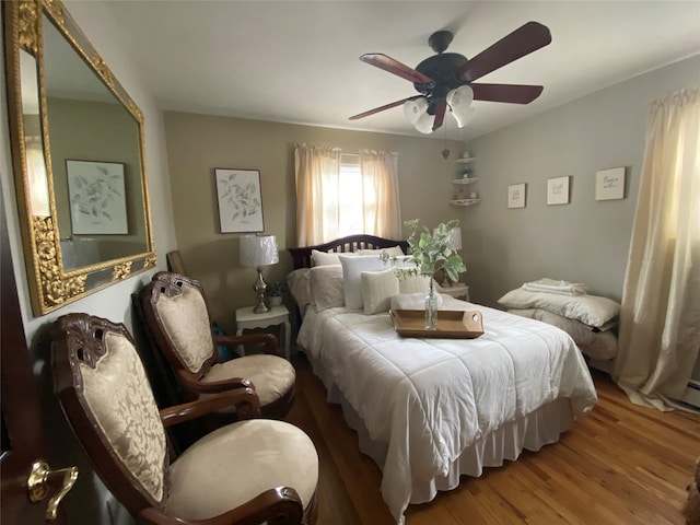 bedroom with ceiling fan and wood finished floors