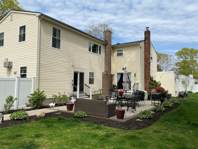 rear view of house featuring a lawn, fence, a patio, and entry steps