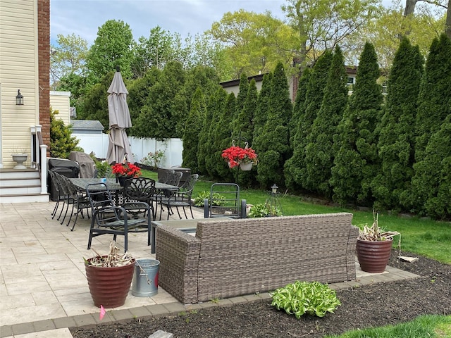 view of patio featuring fence and outdoor dining area