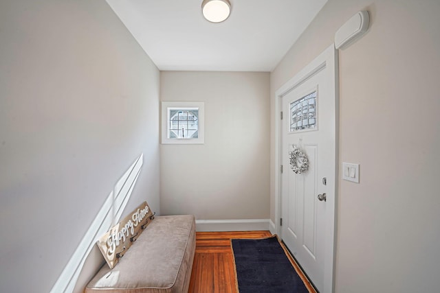 foyer entrance with wood finished floors and baseboards