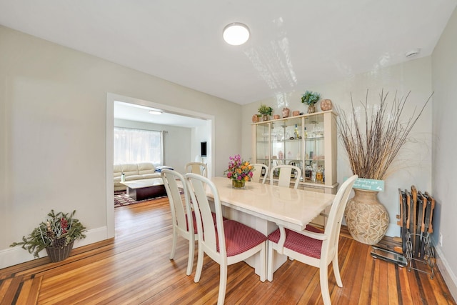 dining room with baseboards and wood finished floors