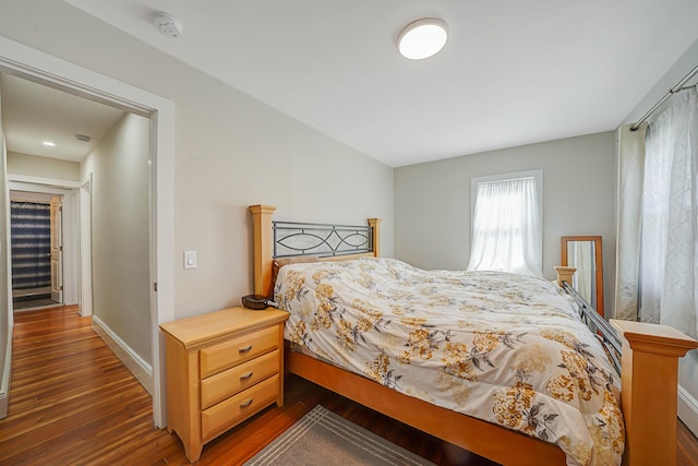 bedroom with wood finished floors and baseboards