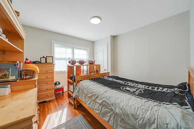 bedroom with hardwood / wood-style floors