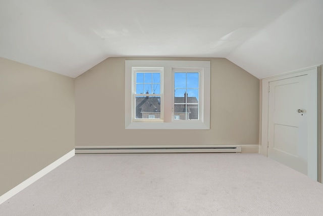 bonus room featuring carpet floors, a baseboard radiator, baseboards, and vaulted ceiling