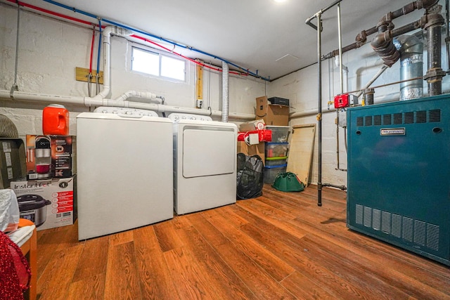 laundry area with laundry area, separate washer and dryer, and wood finished floors