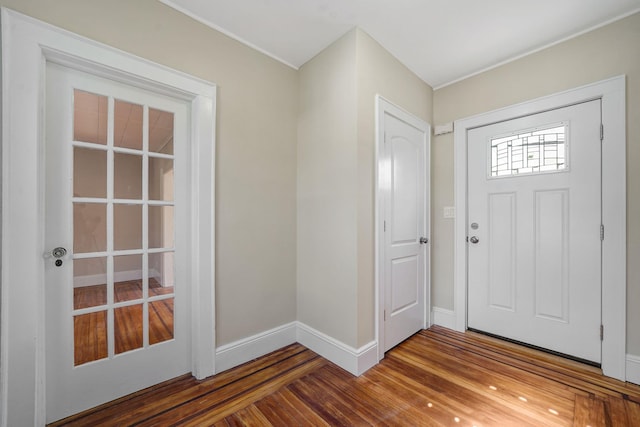 entrance foyer with baseboards and wood finished floors