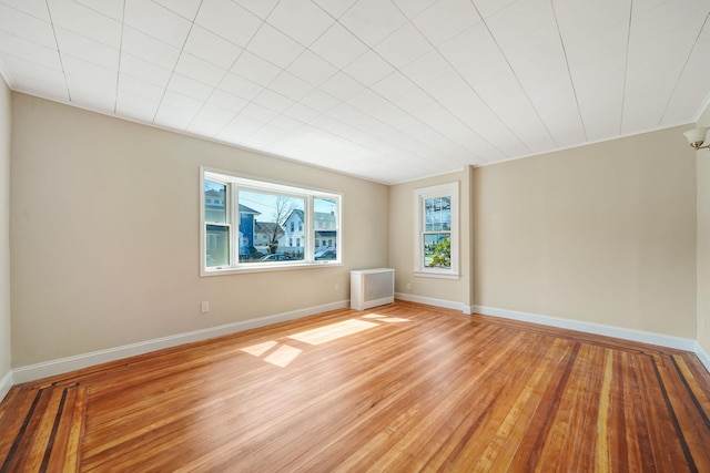 spare room featuring light wood-style flooring and baseboards