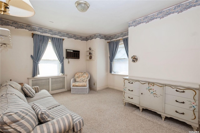living area featuring light carpet, radiator heating unit, a wall mounted air conditioner, and baseboards