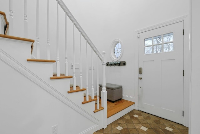 entrance foyer featuring baseboards and stairway