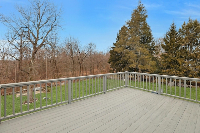 wooden deck featuring a lawn