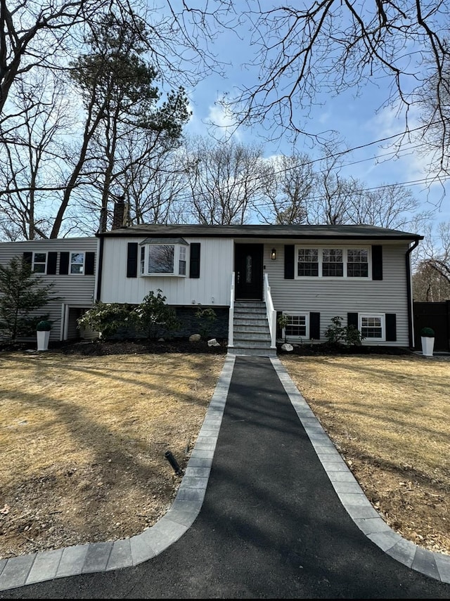 view of front of home featuring a chimney and a front yard