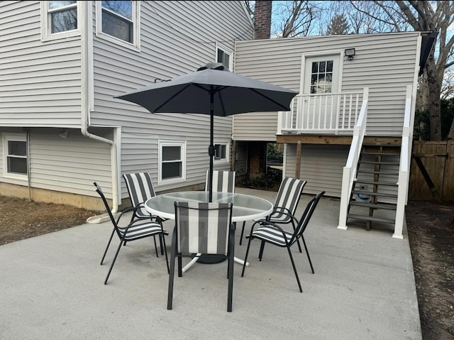 view of patio / terrace with fence, stairway, and outdoor dining space