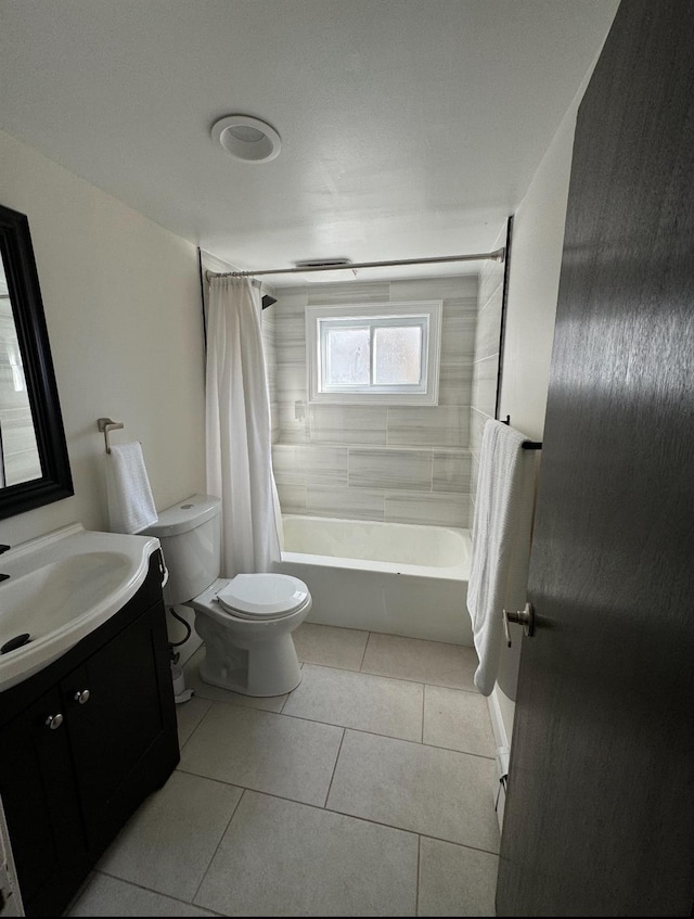 bathroom featuring shower / tub combo, vanity, toilet, and tile patterned floors