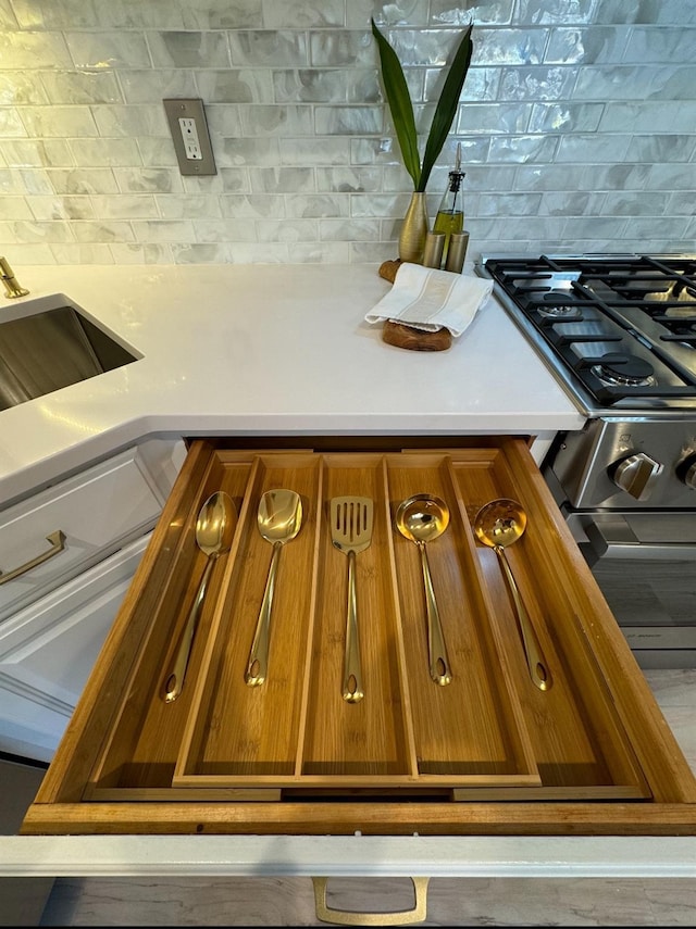 details featuring brown cabinetry, light countertops, and backsplash