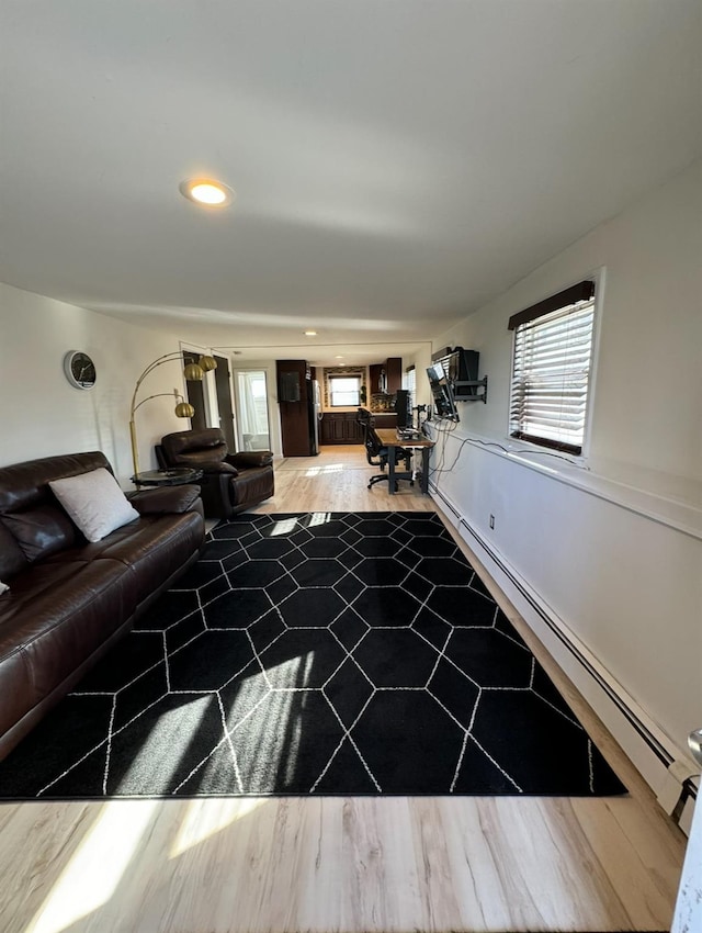 living room featuring a baseboard radiator, wood finished floors, and recessed lighting