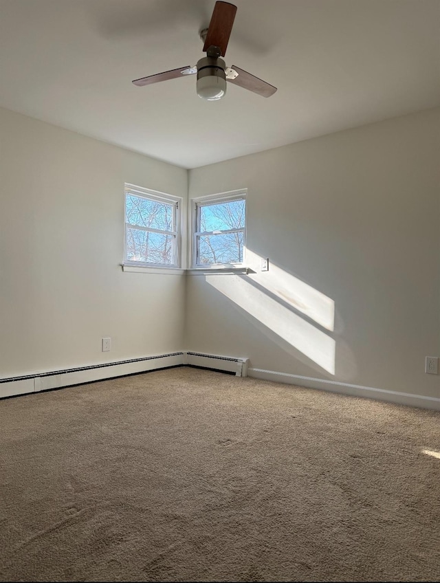 carpeted spare room featuring ceiling fan, a baseboard radiator, and baseboards