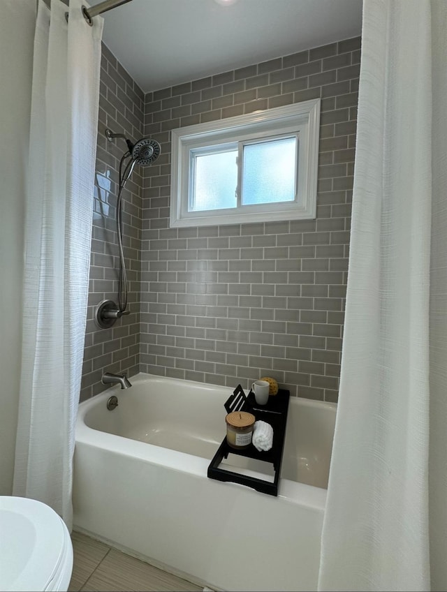 bathroom featuring tile patterned floors and shower / tub combo with curtain