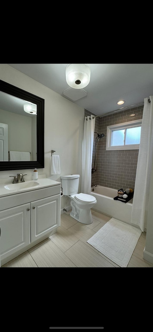 bathroom featuring shower / bath combo, vanity, and toilet