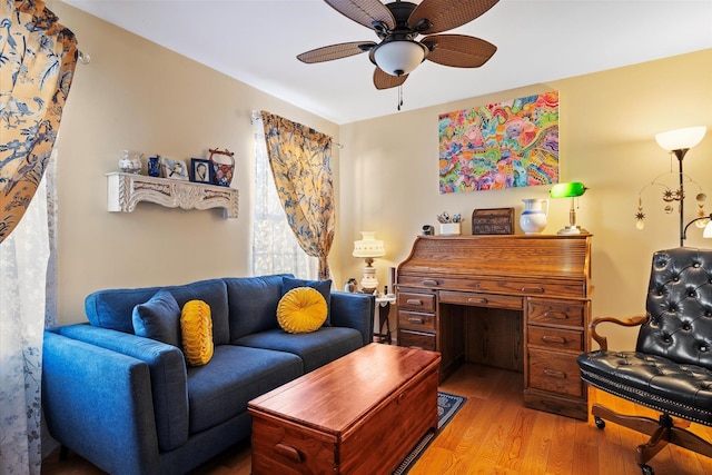 living room with light wood finished floors and ceiling fan