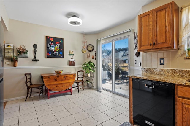 dining area with light tile patterned floors and baseboards