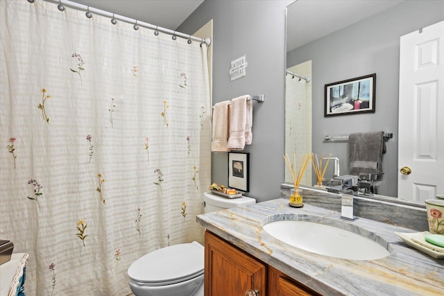 full bathroom with toilet and vanity