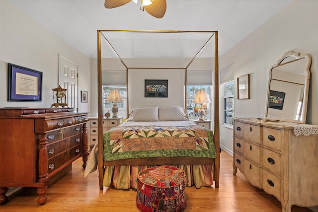 bedroom with multiple windows and light wood-style flooring