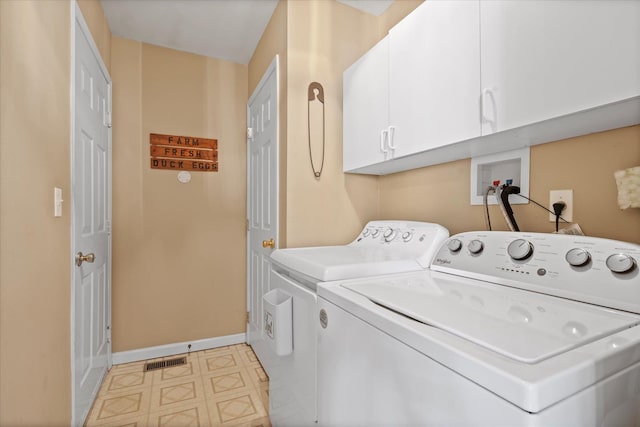 laundry area featuring visible vents, separate washer and dryer, cabinet space, and baseboards