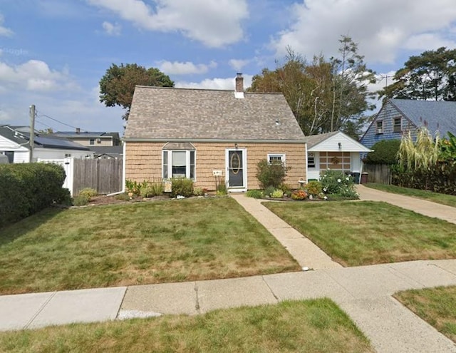 view of front of home with a chimney, a front lawn, and fence