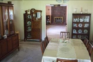 carpeted dining space with a fireplace