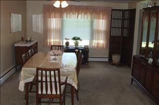 dining space with carpet floors, baseboard heating, a baseboard radiator, and a ceiling fan