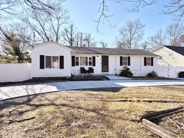 ranch-style home featuring fence