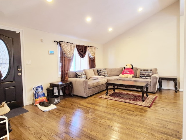 living room with lofted ceiling, baseboards, recessed lighting, and wood finished floors