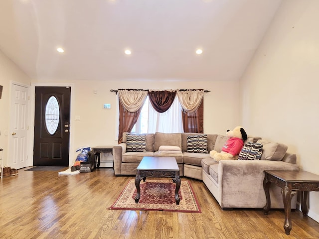 living area featuring recessed lighting, vaulted ceiling, and wood finished floors