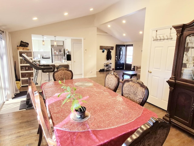 dining area with light wood-type flooring, vaulted ceiling, and recessed lighting