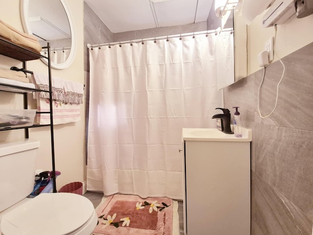 bathroom featuring tile walls, a shower with shower curtain, vanity, and toilet