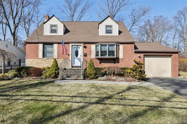 cape cod-style house with brick siding, a front lawn, roof with shingles, a garage, and driveway