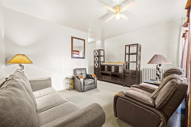 living area featuring ceiling fan and carpet