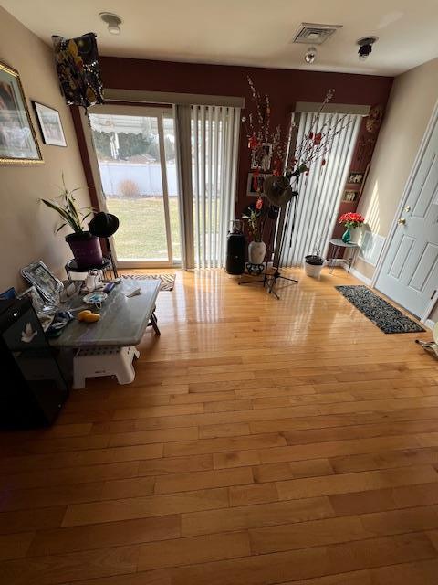 interior space with visible vents and hardwood / wood-style flooring