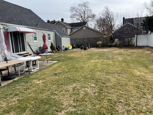 view of yard with entry steps, a patio area, and a fenced backyard