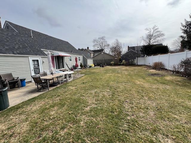 view of yard featuring a patio area and a fenced backyard