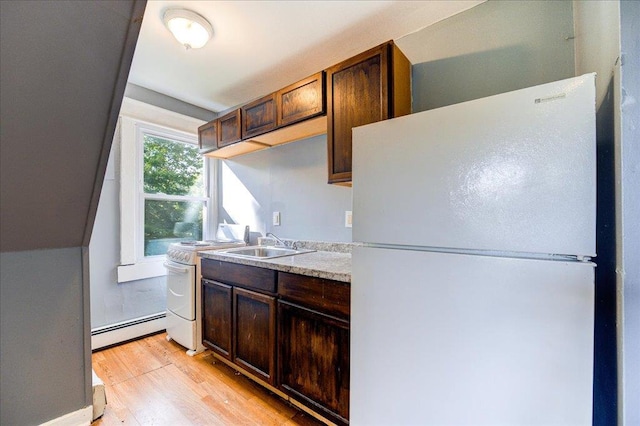 kitchen with light wood-style flooring, a baseboard heating unit, white appliances, light countertops, and dark brown cabinets