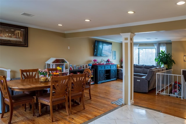 dining space featuring decorative columns, visible vents, crown molding, light wood-type flooring, and recessed lighting