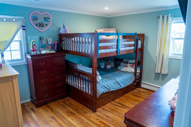 bedroom featuring ornamental molding, a baseboard radiator, and light wood-style flooring