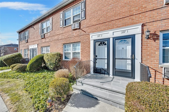 view of exterior entry with brick siding