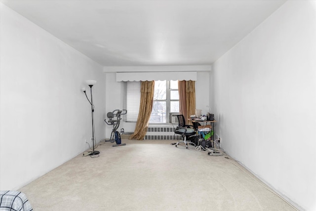 workout room with carpet flooring and radiator heating unit