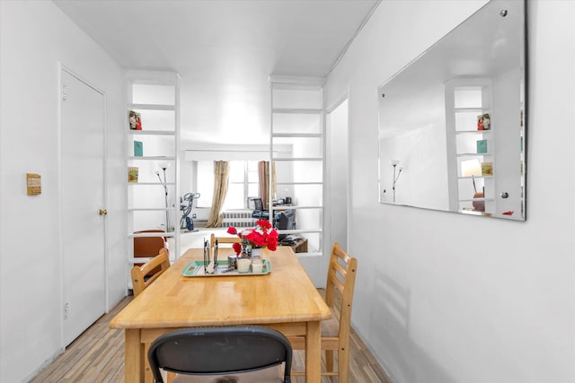 dining space with wood finished floors