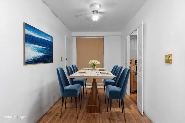 dining area with baseboards, a ceiling fan, and wood finished floors