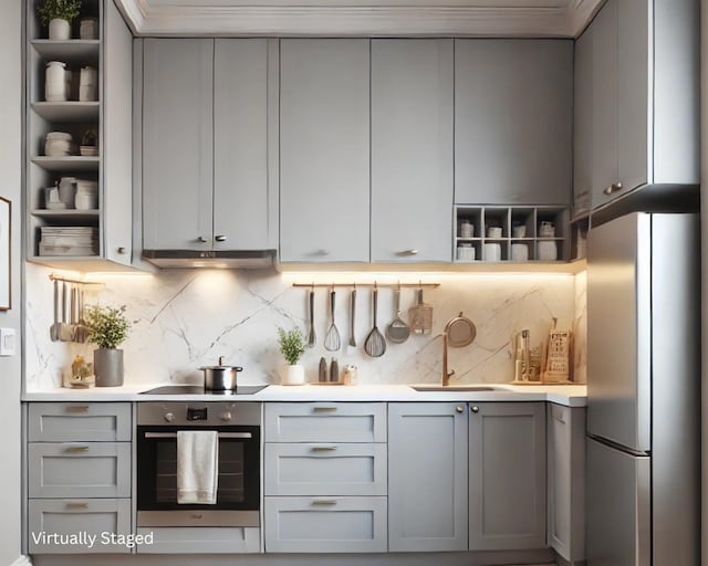 kitchen featuring gray cabinetry, open shelves, under cabinet range hood, stainless steel appliances, and a sink