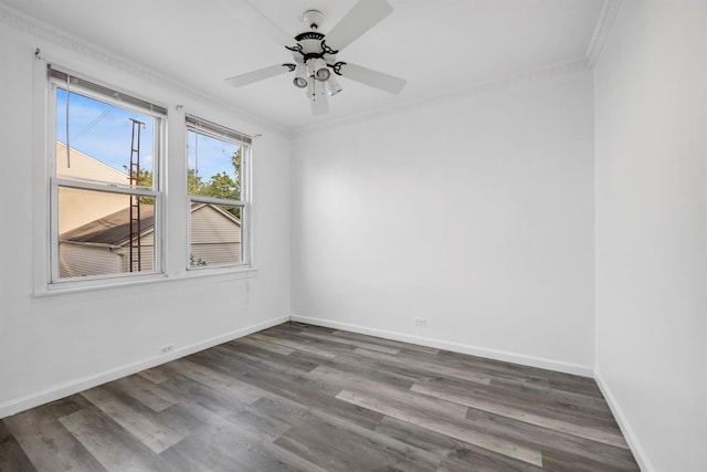 spare room with a ceiling fan, baseboards, ornamental molding, and wood finished floors